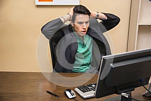 Preoccupied, worried young man staring at computer