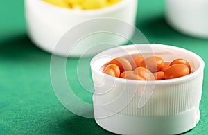 Prepackaged pills and vitamins in white plastic containers