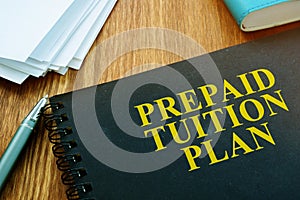 Prepaid Tuition Plan and papers with pan. Loan for education.