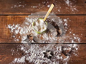 Preparation for baking holiday cookies, flour in a clay jar and silicone shaped tin molds