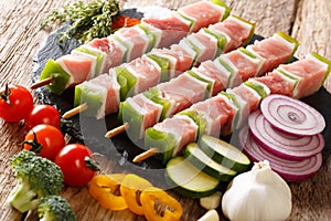 Preparation of barbecue: raw shish kebab with green pepper on sk