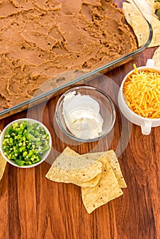 Preparation of bean dip with jalapenos, sour cream and cheddar c