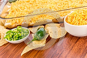 Preparation of bean dip with jalapenos, sour cream and cheddar c