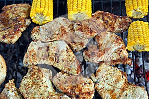 Preparation for the burger on the grill. Meat, bread, corn on th