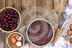 Preparation of a chocolate cake with a cherry. Traditional American cake. Ingredients for baking. banner. Flat lay