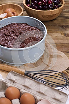 Preparation of a chocolate cake with a cherry. Traditional American cake. Ingredients for baking. Copy space