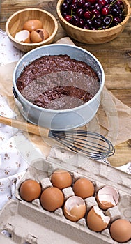 Preparation of a chocolate cake with a cherry. Traditional American cake. Ingredients for baking. Vertical banner.