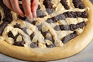 Preparation of Chodsky kolac - decorating the cake with sliced almonds