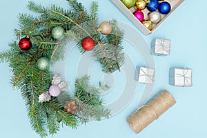 Preparation for Christmas wreath. Spruce branch, ornaments. Blu