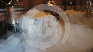 Preparation of cocktails with dry ice. Steam from dry ice slowly diverge