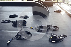 In preparation for a concert, audio cables and speakers are on the stage podium