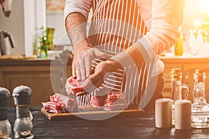 Preparation of dinner. Cooking, processing of meat beef, tenderloin . Person man`s hands marinates meat - sprinkles with