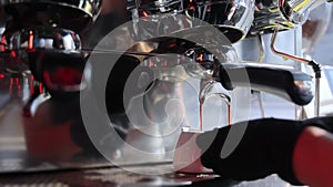 Preparation of double coffee in white cups close-up. Making espresso in a cafe