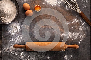 Preparation for dough cooking. Top view of board, rolling pin and flour