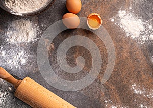 Preparation for dough cooking. Top view of board, rolling pin and flour