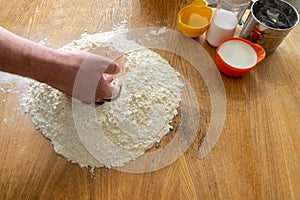 Preparation of dough, flour, eggs and wooden rolling pin on gray background