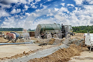 Preparation of drilling mud on a construction site against a background of blue sky. Exploration of useful minerals. Industry and