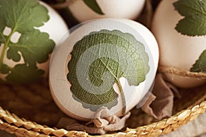 Preparation of Easter eggs for dyeing with onion skins with a pattern of fresh leaves