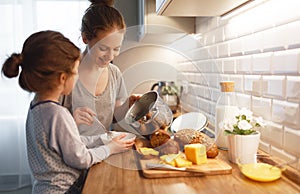 Preparation of family breakfast. mother and child daughter cook