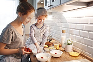 Preparation of family breakfast. mother and child daughter cook