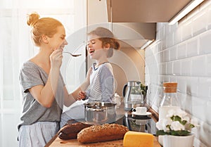 Preparation of family breakfast. mother and child daughter cook