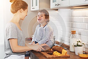 Preparation of family breakfast. mother and child daughter cut b