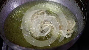 Preparation for the festival Homemade Murukku recipes. Indian snacks made during the Deepavali festival in India are fried in hot