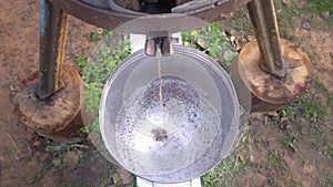 Preparation of fresh apple juice with an old fruit press. Squeezing of fresh apples in wooden press to bucket to produce