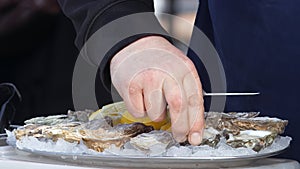 Preparation of fresh oysters for the customer at the street market