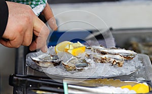 Preparation of fresh oysters for the customer at the street market