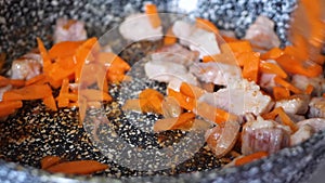 Preparation of grilled pork meat with fried carrot