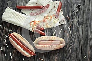 preparation of hot dogs with sausage.photo on a wooden background