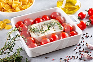 Preparation of ingredients for fetapasta. Trending Feta bake pasta recipe made of cherry tomatoes, feta cheese, garlic and herbs