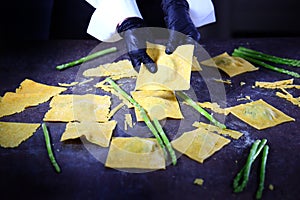 Preparation of large ravioli from corn dough. Asparagus filling. An unrecognizable person. Concept of cooking. Healthy