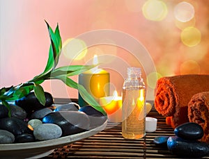 Preparation for massage in orange with dish, oil and bamboo