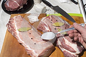 Preparation of meat for smoking.