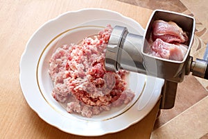 Preparation of minced meat with a manual meat grinder.