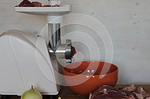 Preparation of minced meat, using an electric grinder.