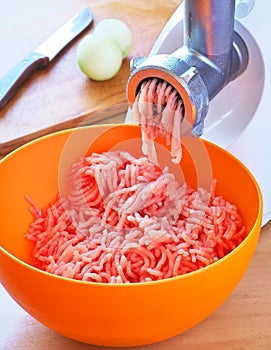 Preparation of minced meat using a meat grinder.