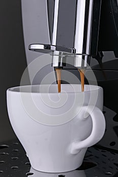 Preparation morning black aromatic Americano coffee beans from professional coffee machine. Hot Wake-up coffee with