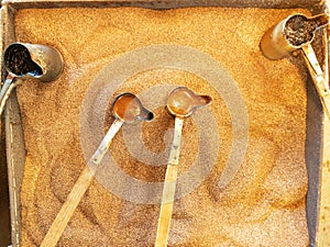 Preparation of natural coffee in Turks on the sand.