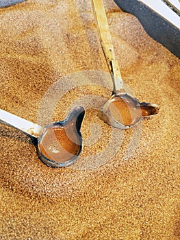 Preparation of natural coffee in Turks on the sand.