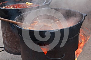 Preparation pilaf in the pan over an open fire