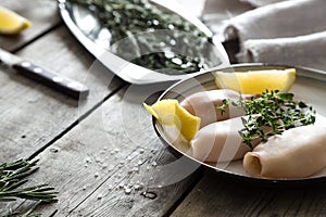 Preparation of raw squid and ingredients on the table