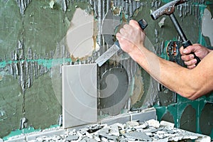 Preparation of repair the bathroom. Man Removing old tiles