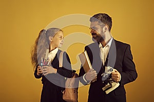 Preparation for school. Girl with bag and bearded man. Classroom and alternative education