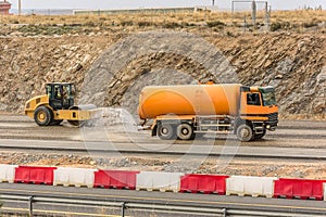 Preparation of surface with water tank truck for asphalted