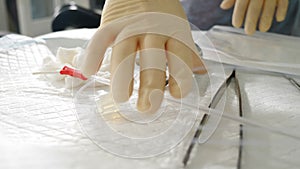 Preparation for Surgery. Close-up shot of nurse in operating room preparing scalpels and medical instruments, putting