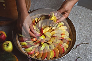 Preparation, Thanksgiving Day celebration. The chef finishes adding apples to the pie. Making a traditional apple pie