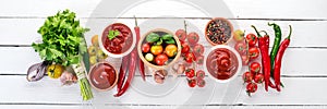 Preparation of tomato sauces and seasonings. Cherry tomatoes, spices, chili peppers. Top view.